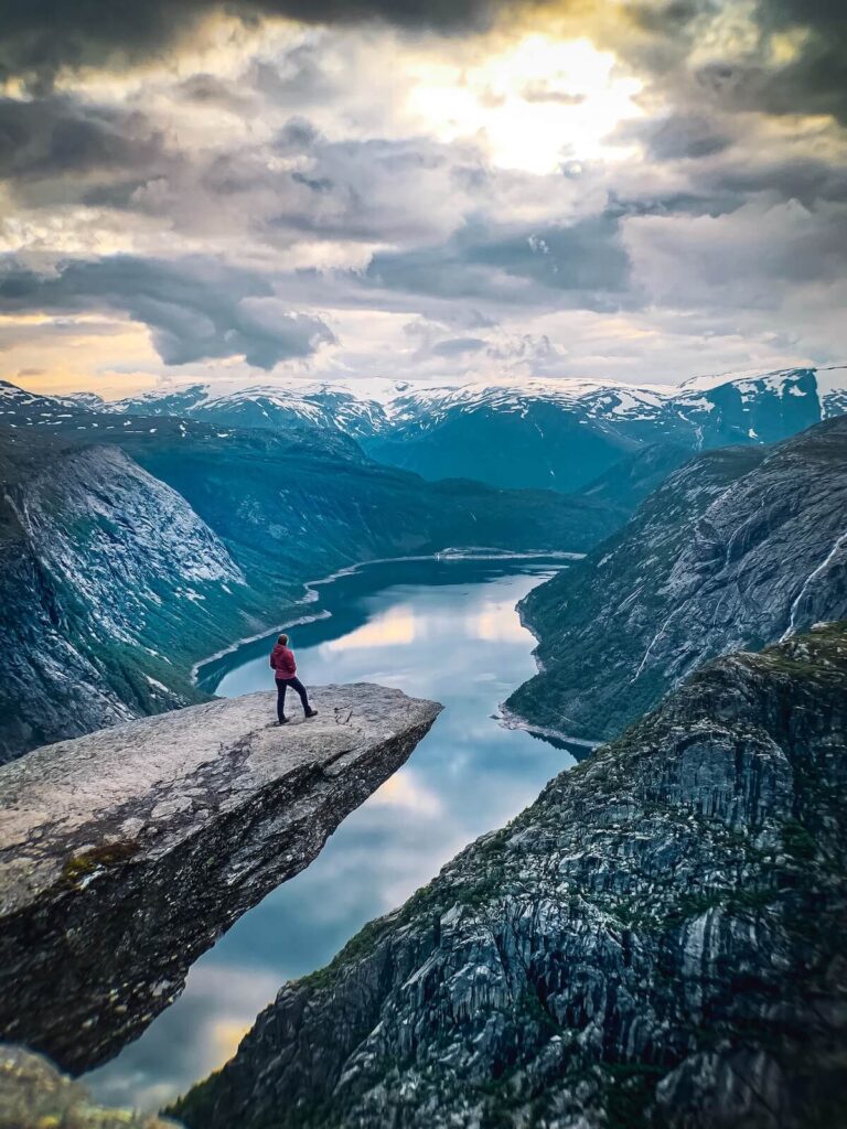 a hiker near the edge of Trolltunga in Norway