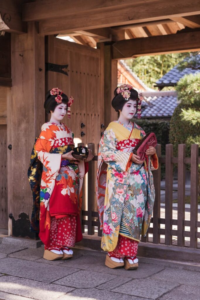 two geisha clad in colorful clothing