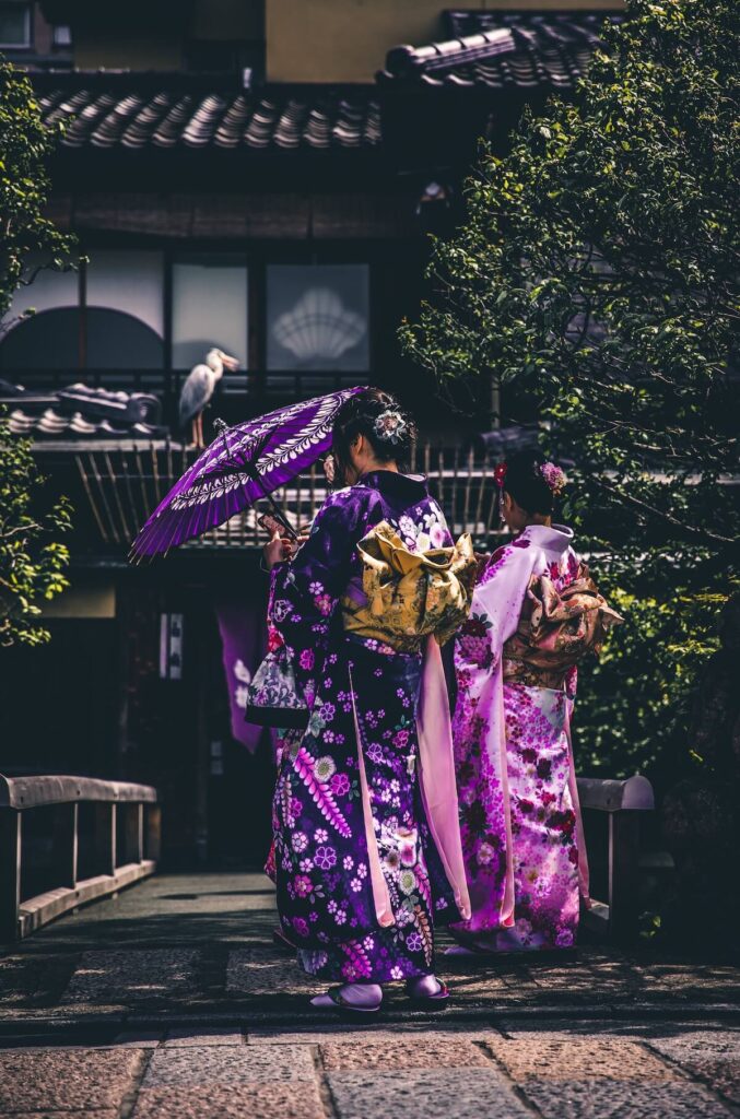 two women wearing silk purple kimon