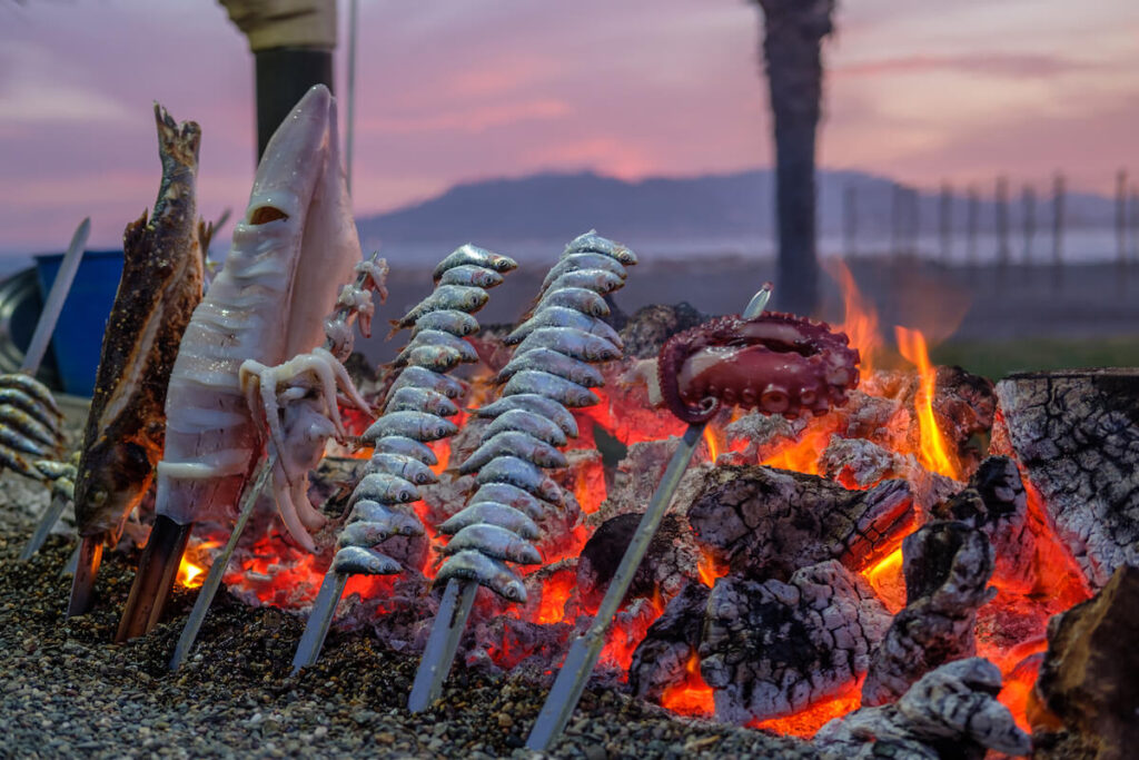 roasting sardines over fire