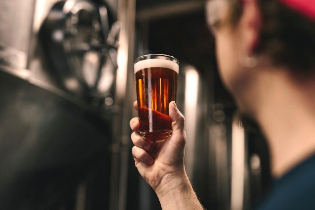 man holding craft beer