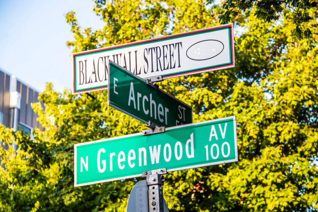 Black Wall Street and N Greenwood Avenue and Archer street signs in Tulsa Oklahoma