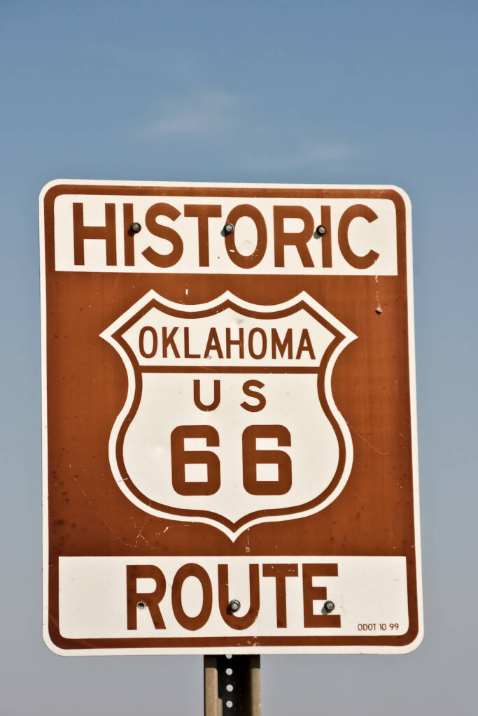 Historic brown and white sign on US Route 66 in Oklahoma