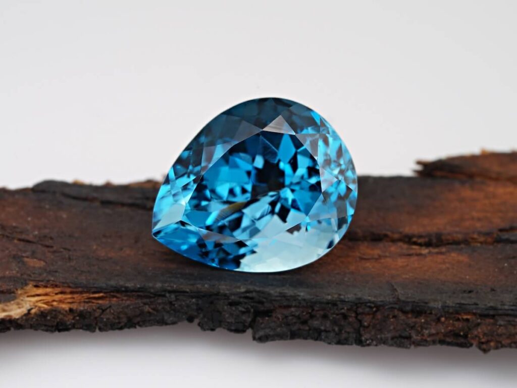 Yogo sapphire on wooden table