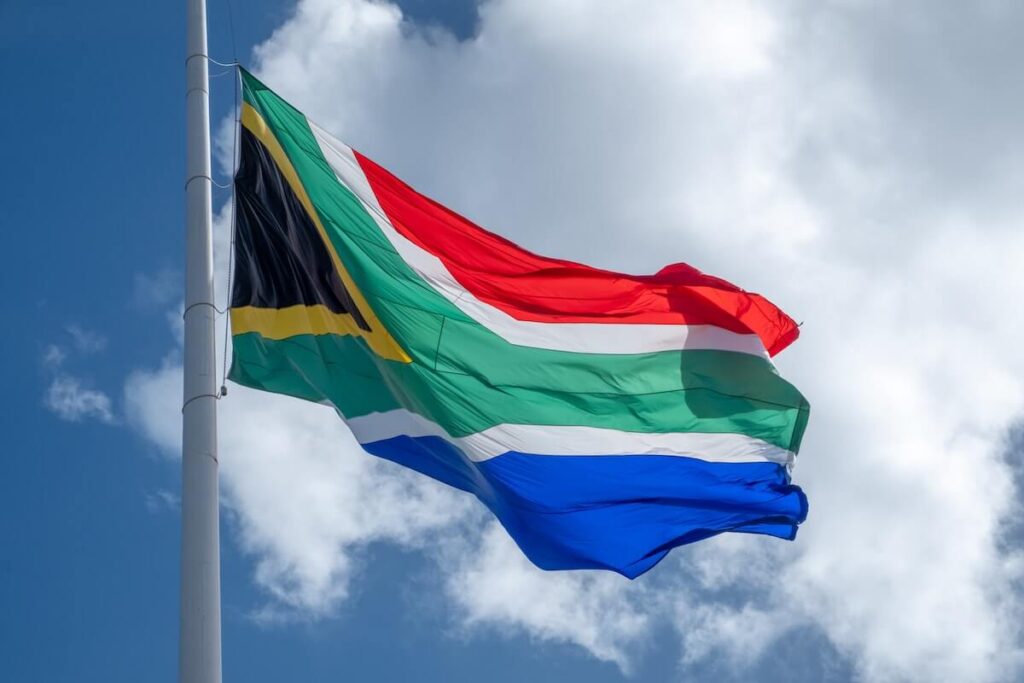 South-African national flag in the wind with cloud in the back