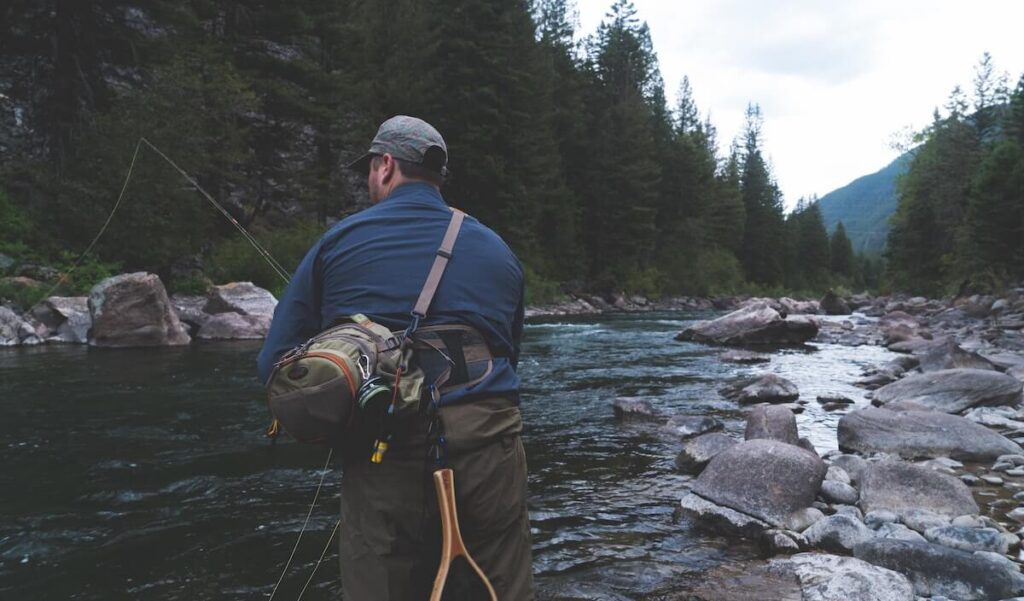 man fly fishing in a river in Montana