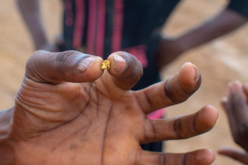 Ghanaian Illegal miner finds a small nugget of gold