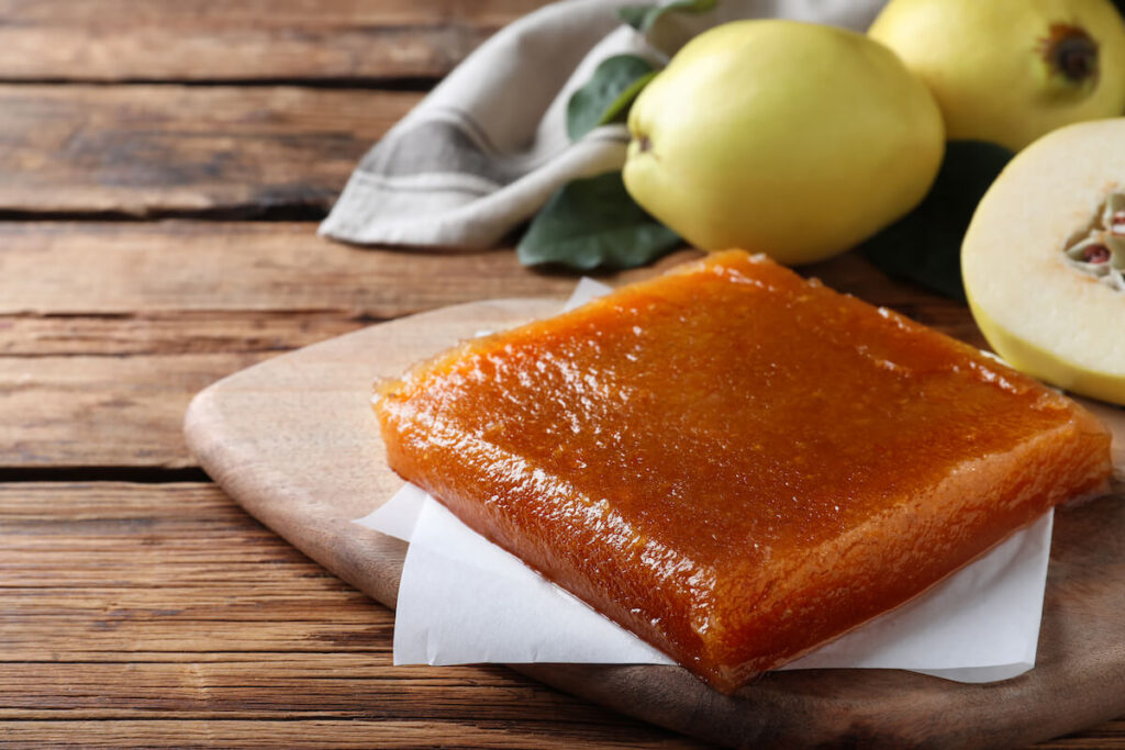 Delicious quince paste on wooden table