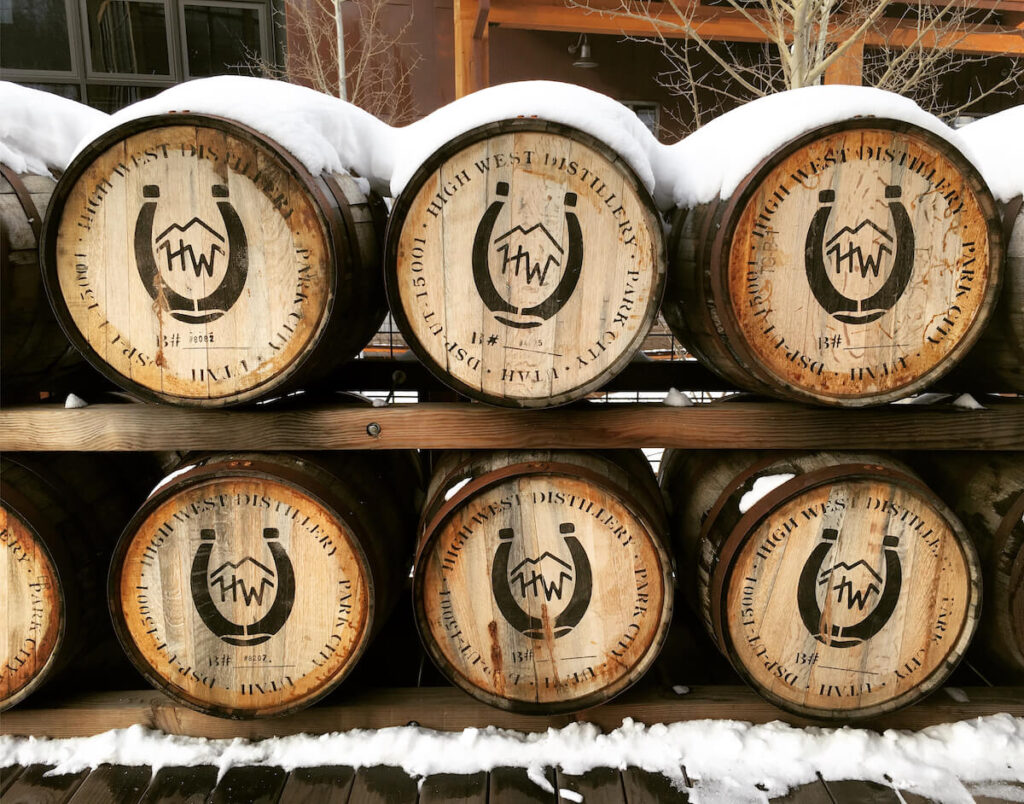 high west distillery whiskey barrels stacked outside in the snow. High west distillery is a popular tourist attraction in utah