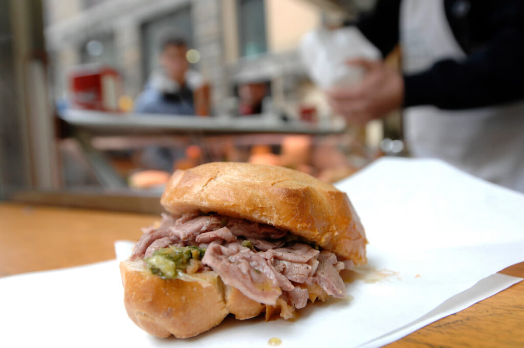 Lampredotto is the typical street food of the city of Florence in Tuscany and is a sandwich with a cow's stomach in a tomato sauce and put to stew