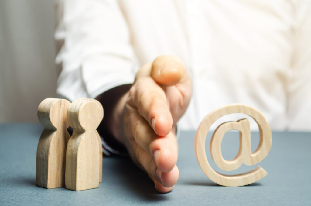 A man's hand separates people from the Internet to illustrate the concept of blocking access to the internet, self-isolation and traffic filtering