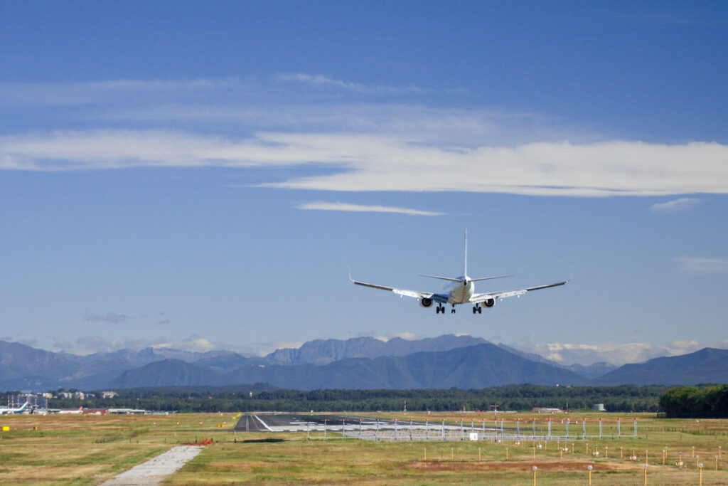 plane flying over Malpensa airport