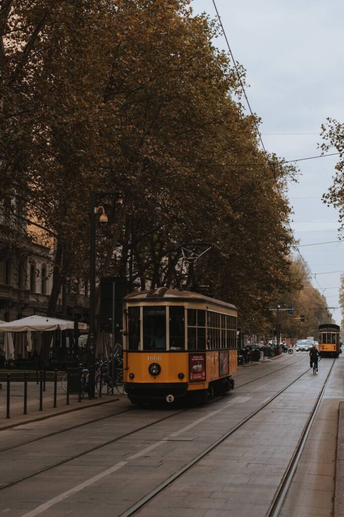 trams and a man cycling in Milan