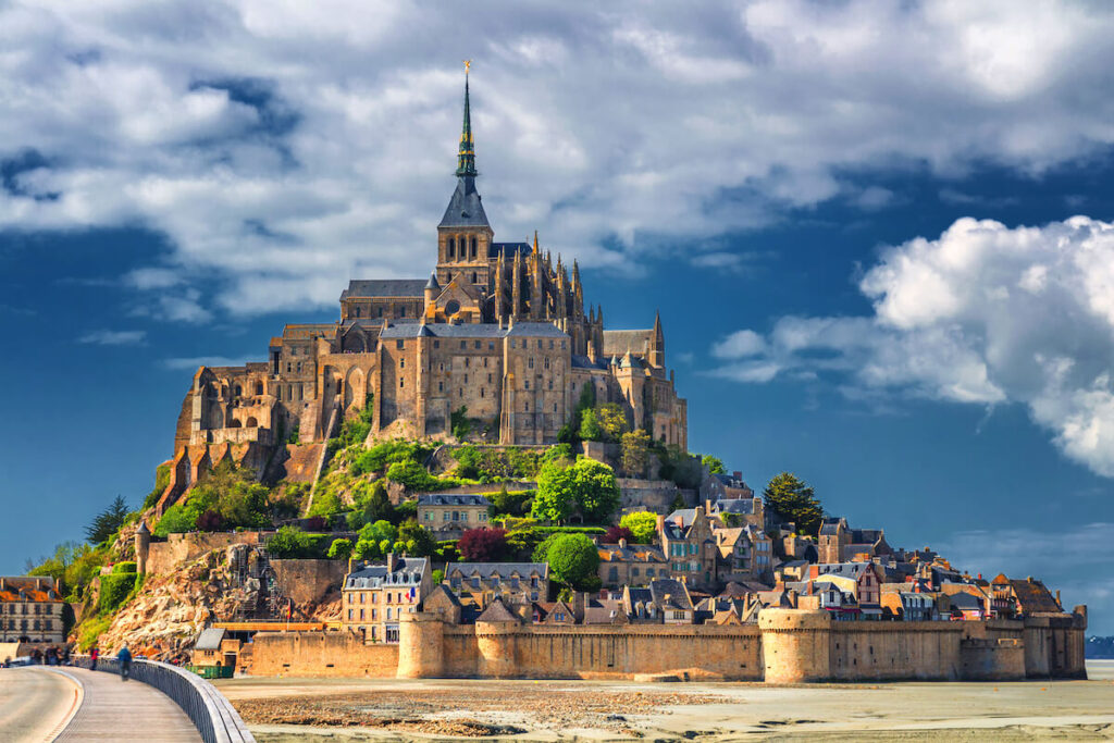 Beautiful panoramic view of famous Le Mont Saint-Michel tidal island with blue sky