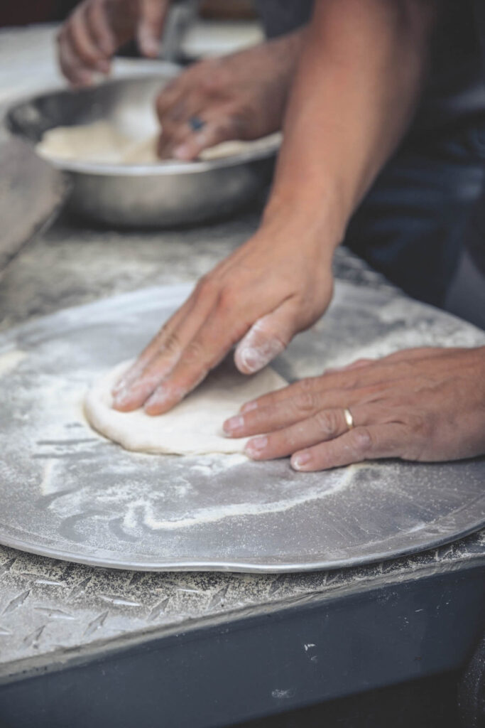 Man preparing pizza dough. Pizza is a huge part of Italian food culture