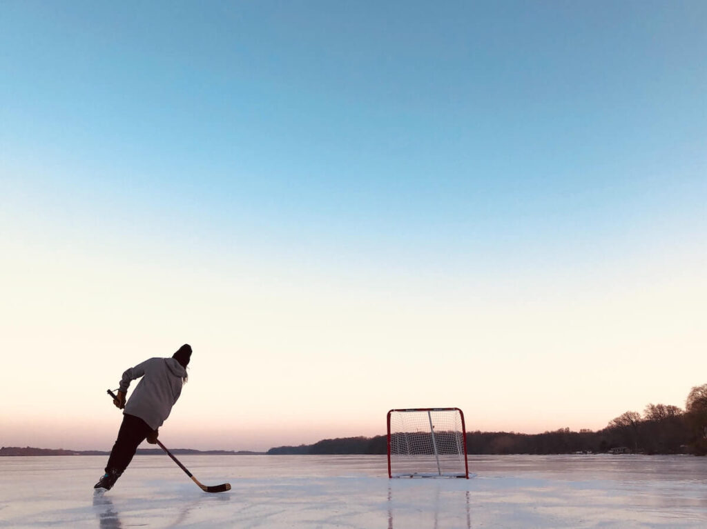 woman playing Pond hockey in Minnesota