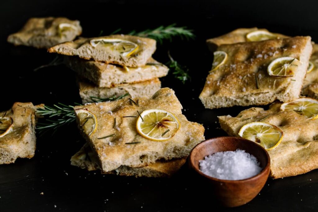 Lemon rosemary focaccia on a dark background
