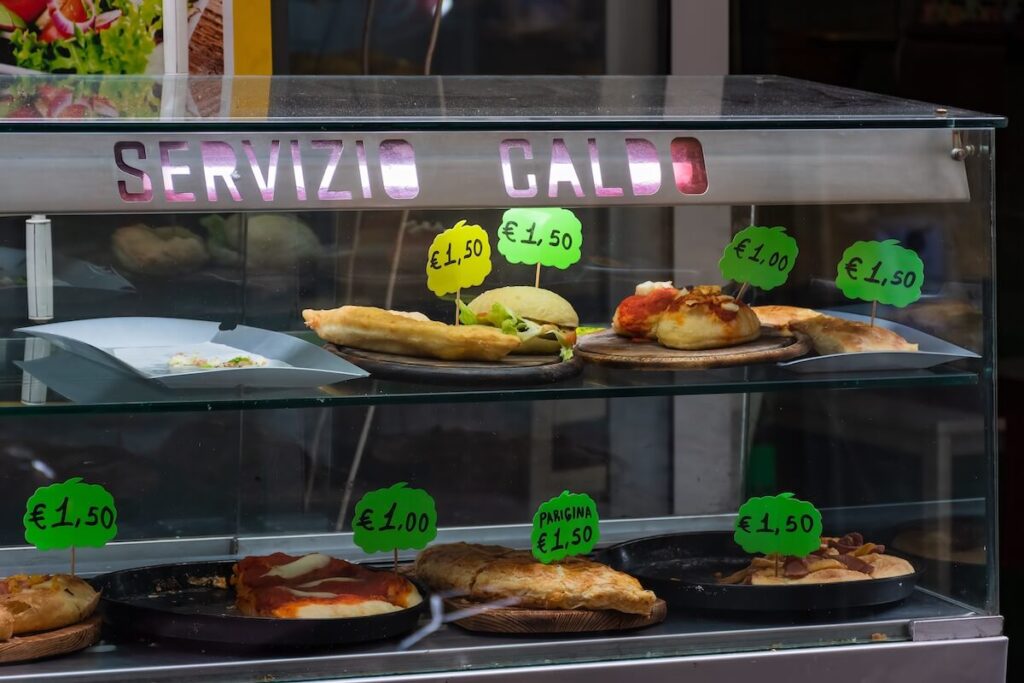 Street food in showcase with prices in the historic centre of Naples, Italy