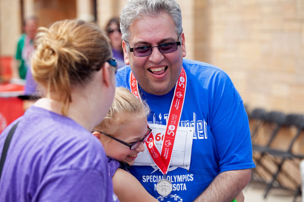 Special Olympics for developmentally delayed members event at St. Thomas University laughing and received an award