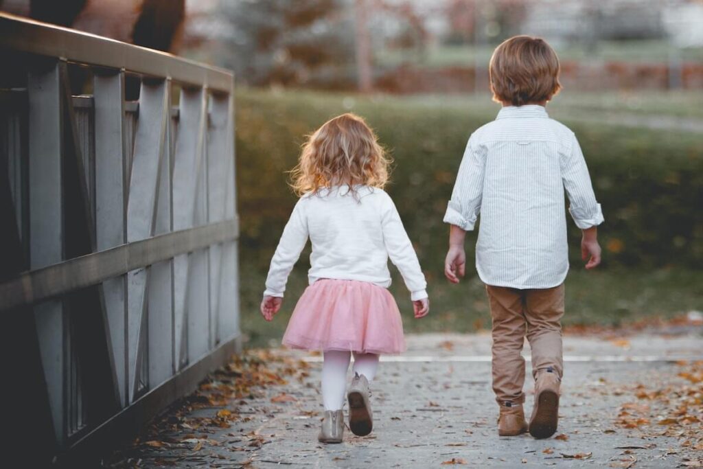 two kids walking in the park
