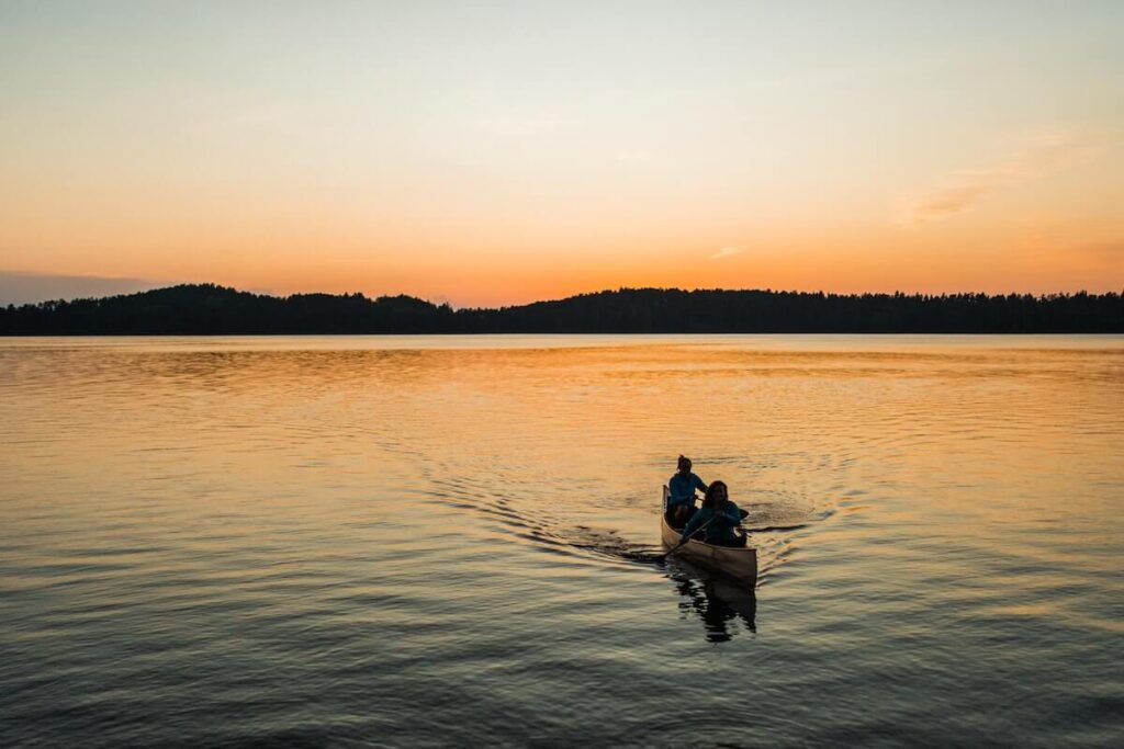 Two people canoeing in the BWCA at twilight