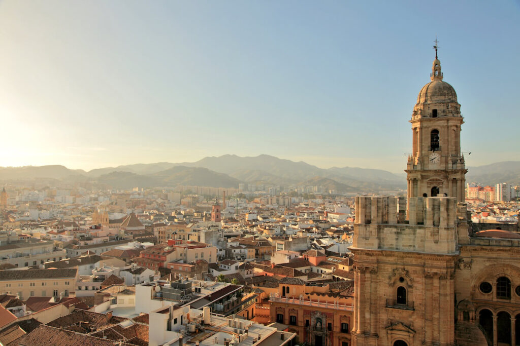 sun shining over the Cathedral of Malaga