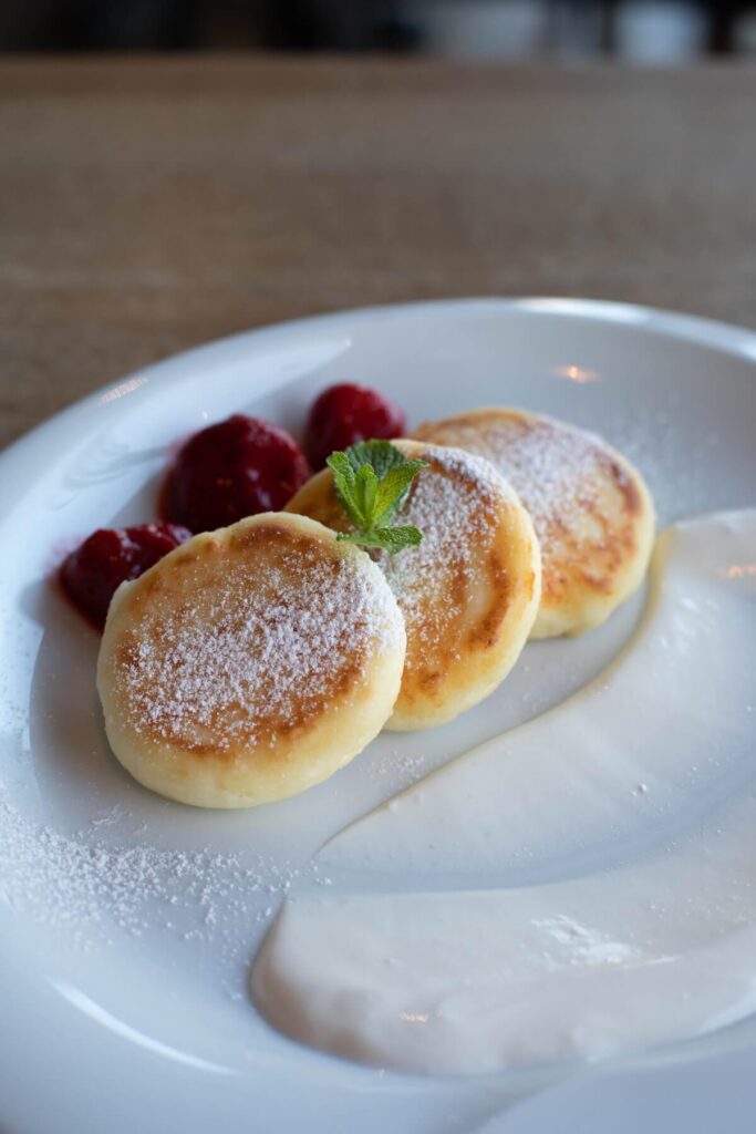 Delicious curd fritters with sour cream in cafeteria