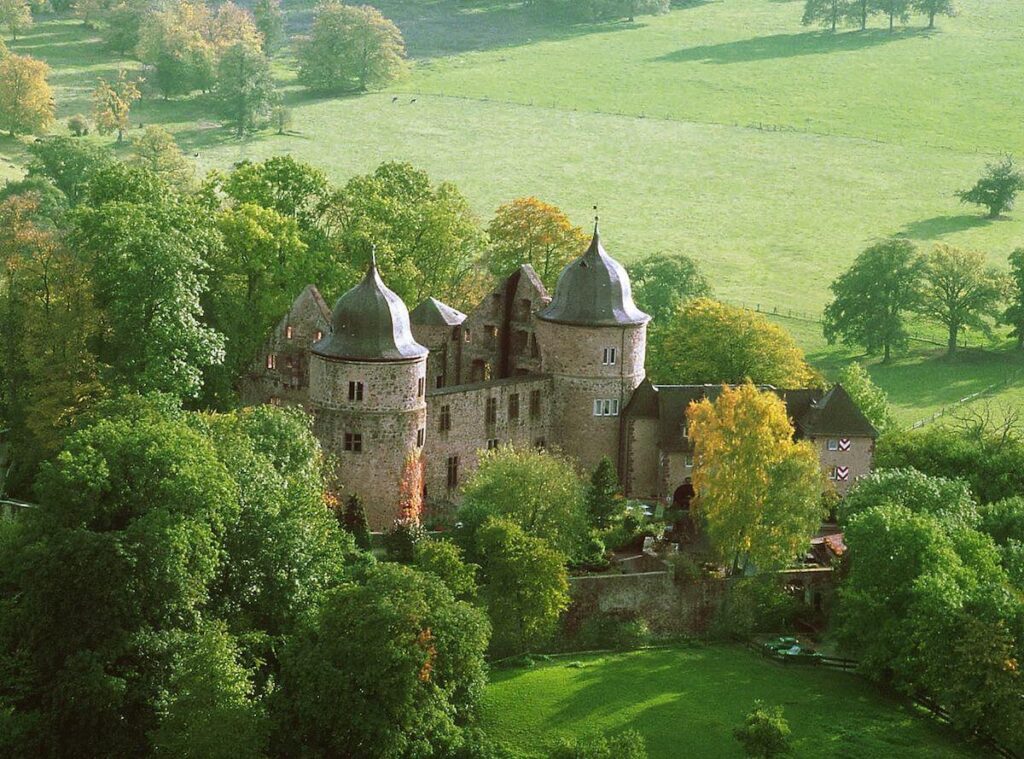 aerial shot of Dornröschenschloss Sababurg and surrounding forest