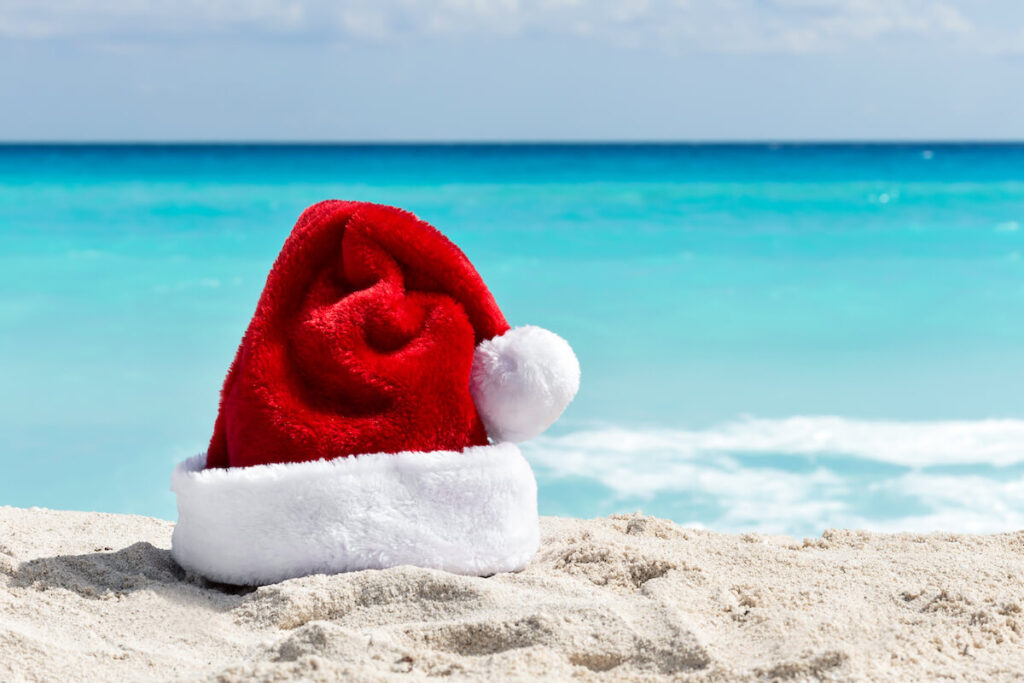 Santa Claus hat at caribbean sandy beach
