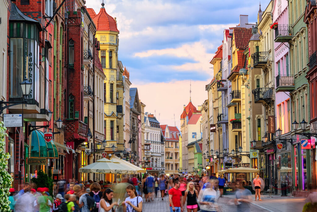 Crowded pedestrian street on a summer evening in the old town of Torun