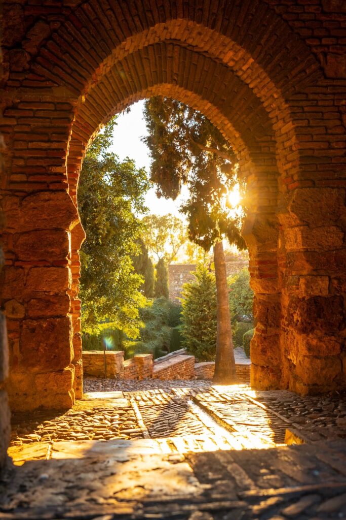 Sunset at the gate of the wall and the gardens of the Alcazaba in the city of Malaga, Andalusia