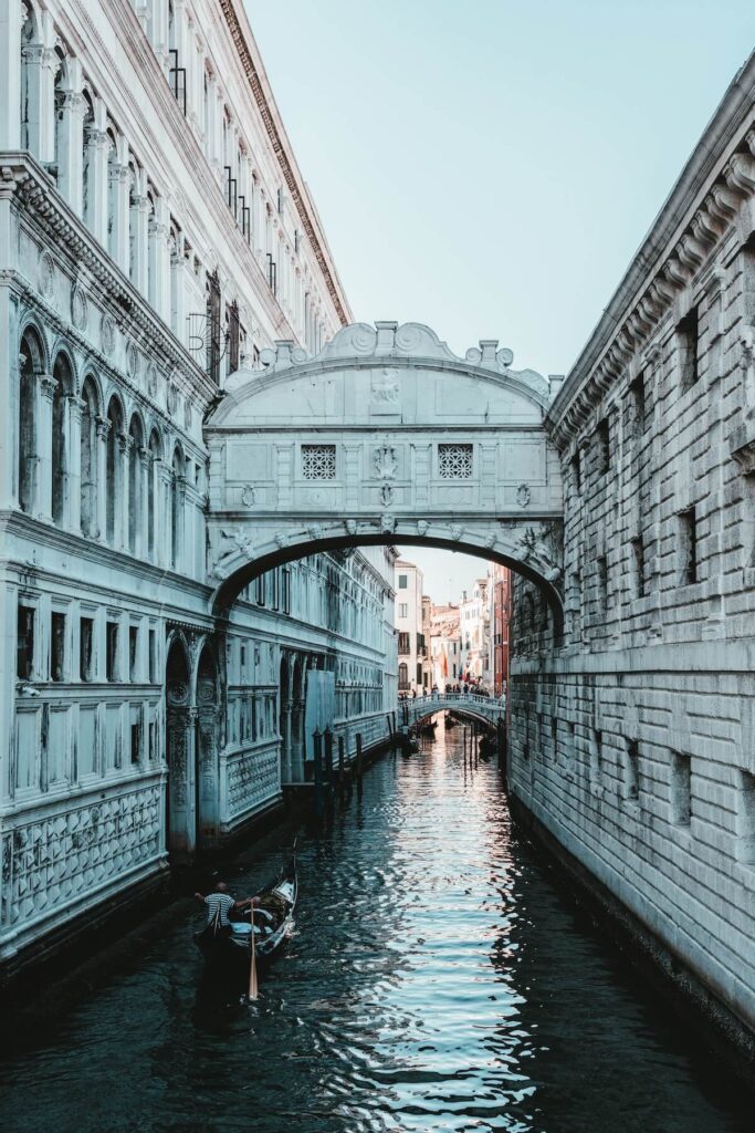 Boat sailing and view of Bridge of Sighs in Venice