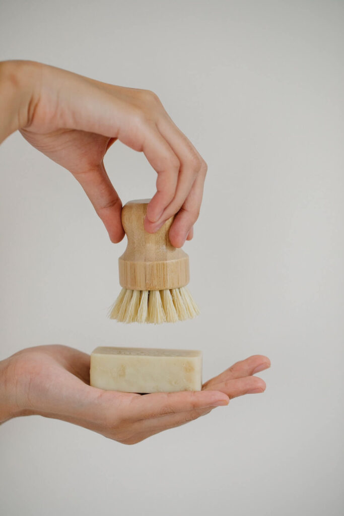 woman with skin care brush and soap bar