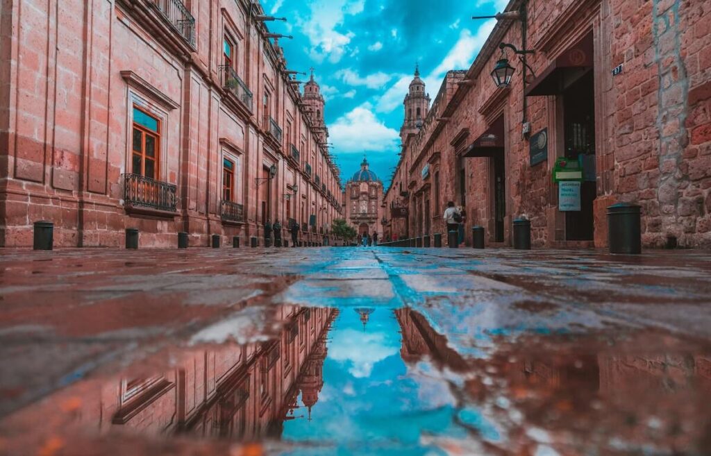 puddle of water reflecting historic street in Morelia, Mexico