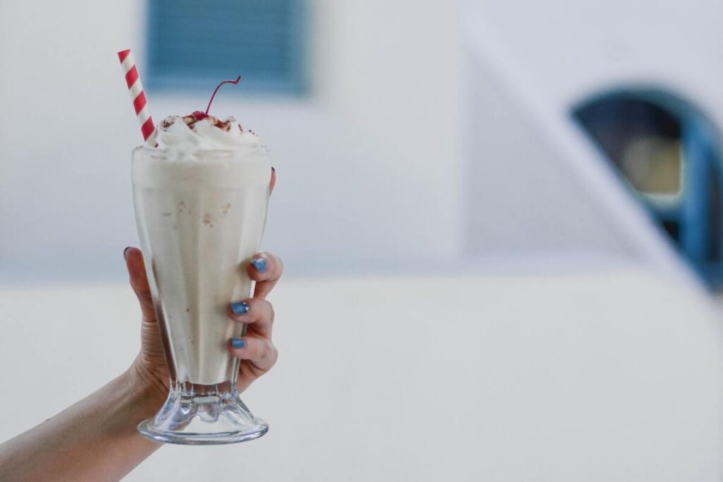 Young female holding a milkshake