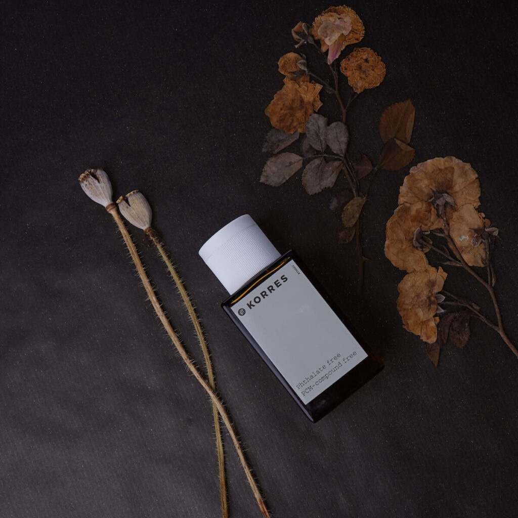 Korres, greek cosmetics, woman perfume with dry flowers on black background