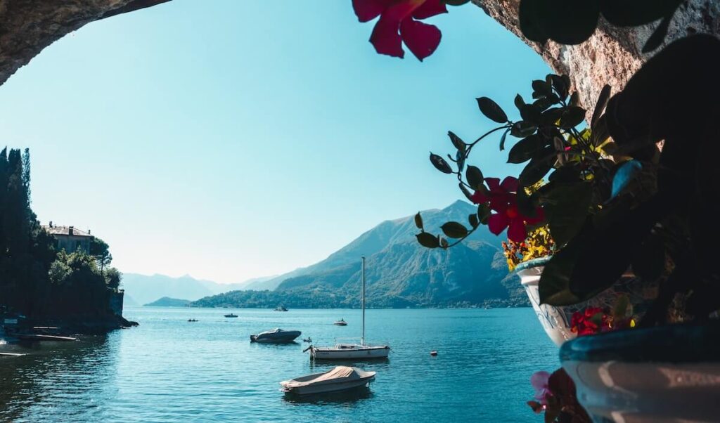 boats sailing along Lake Como in Varenna, Italy