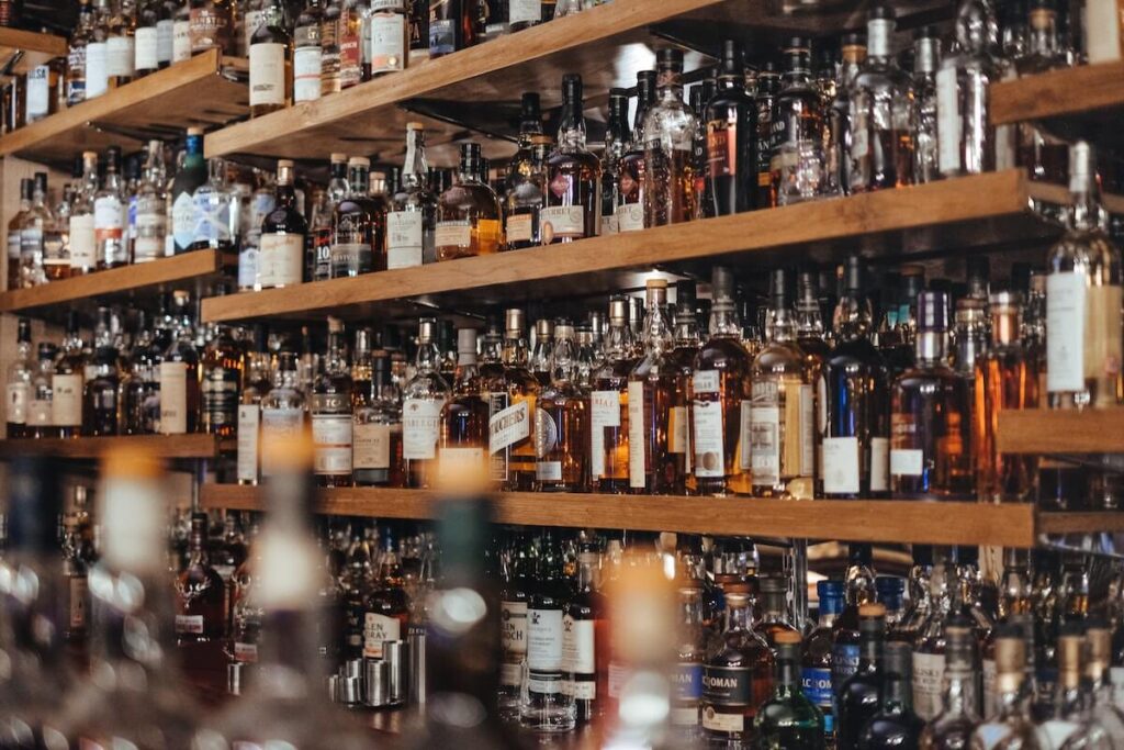 bar with shelves stocked with various alcohol bottles