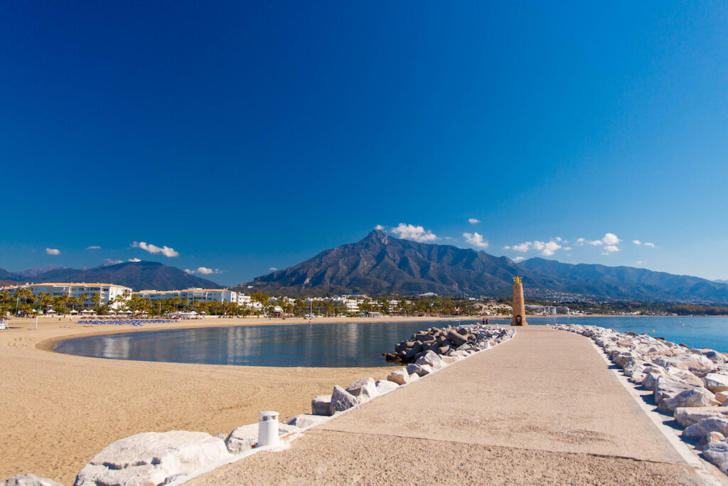 Summer holiday scenery, sandy beach by the blue sea, in Marbella resort on Costa del Sol in Spain