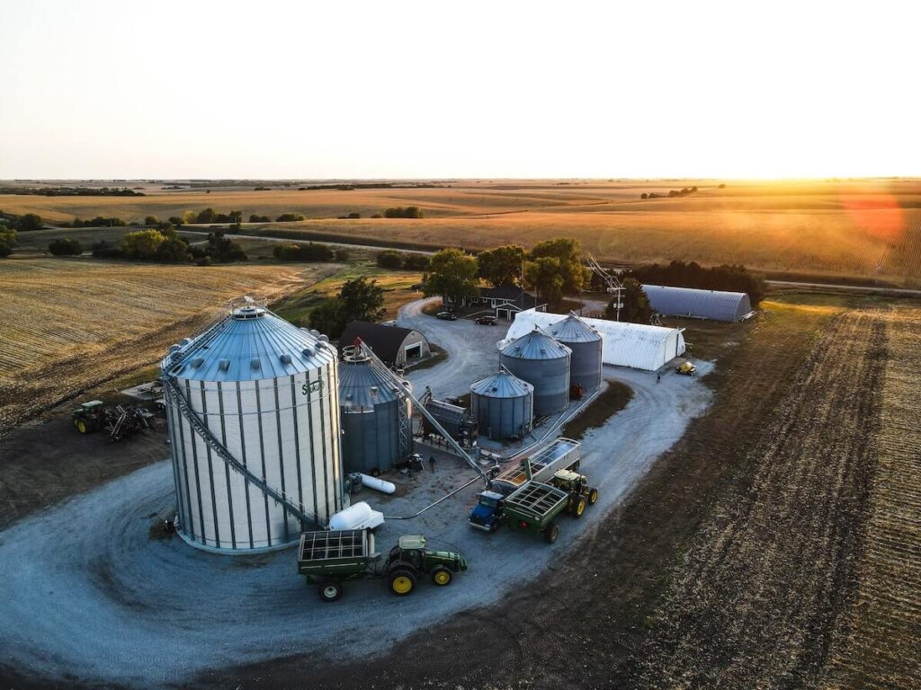 metal silos in wheat field