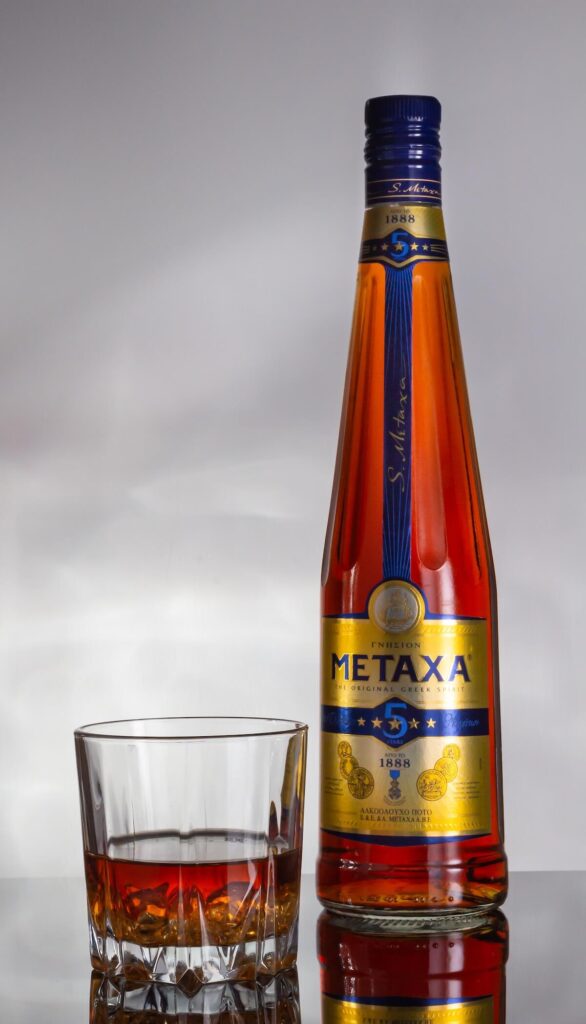Metaxa 5 stars greek alcoholic drink on gray heterogeneous background