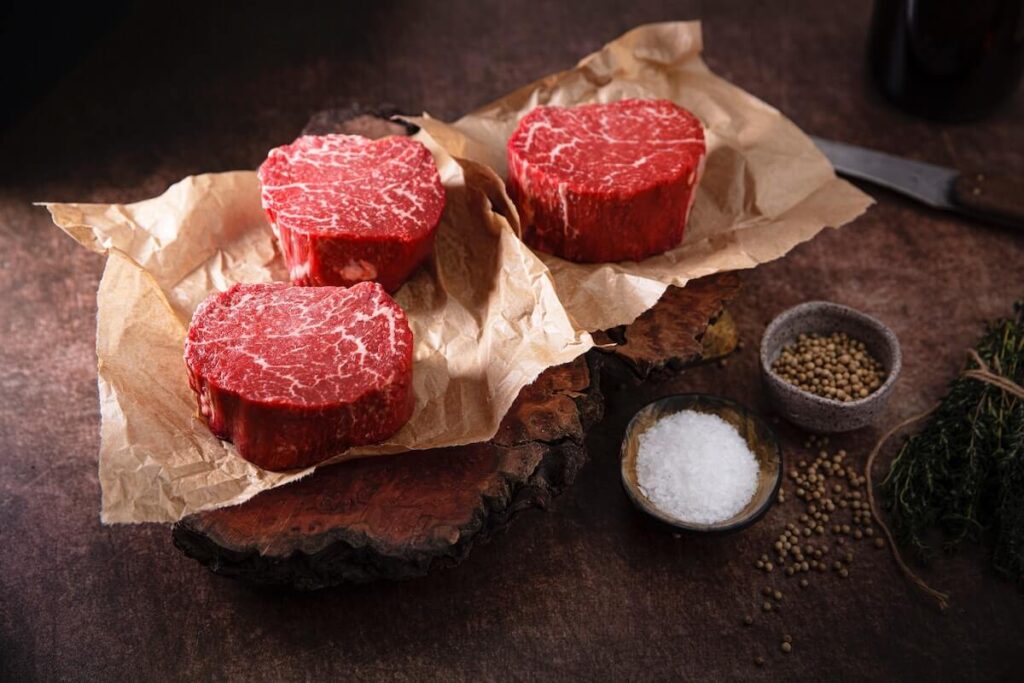 sliced Omaha steak on brown paper
