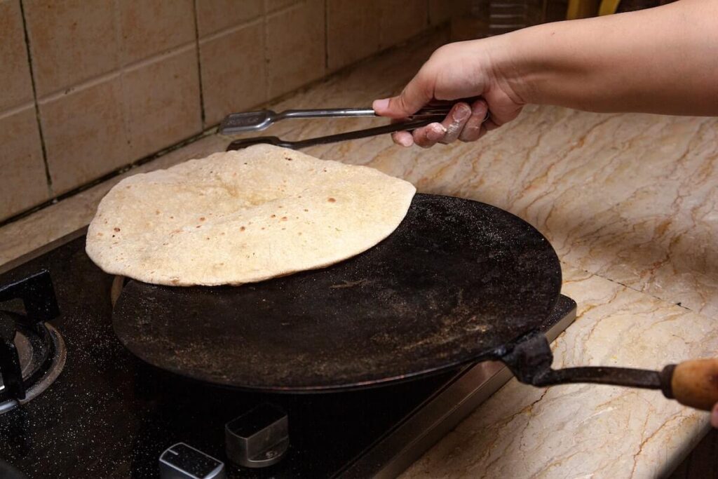 Cooking roti canai on a ceramic plate