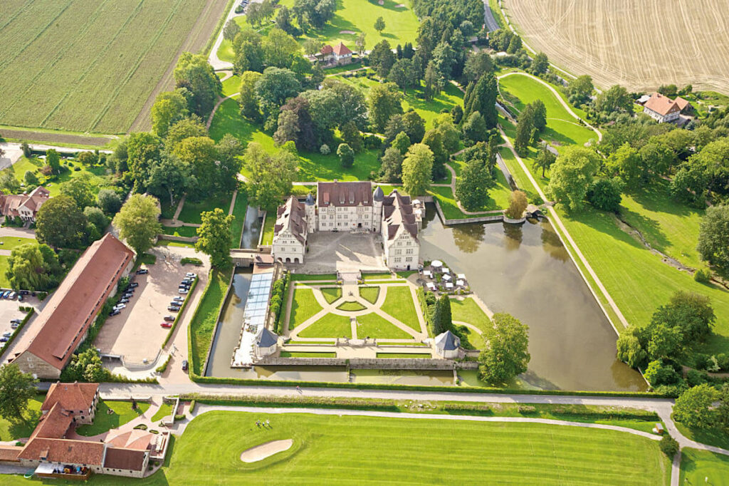 aerial view of Schlosshoteln Munchhausen, courtyard, pond, and English garden