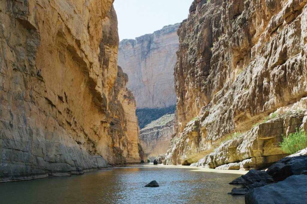River flows in high canyon walls