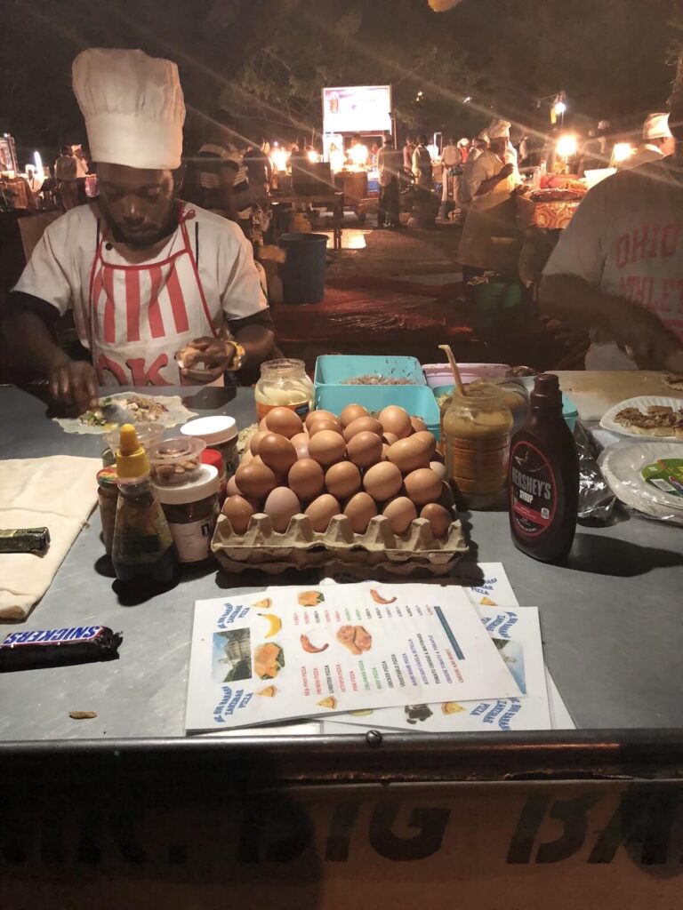 vendor making Zanzibar pizza at night market