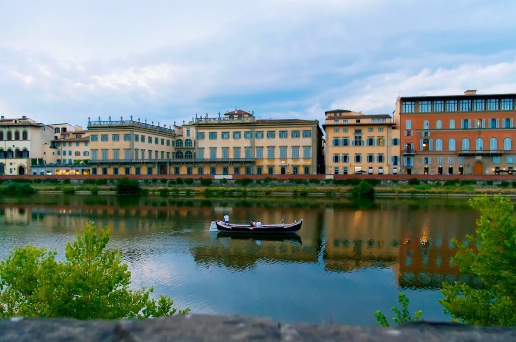 people on boat in arno river