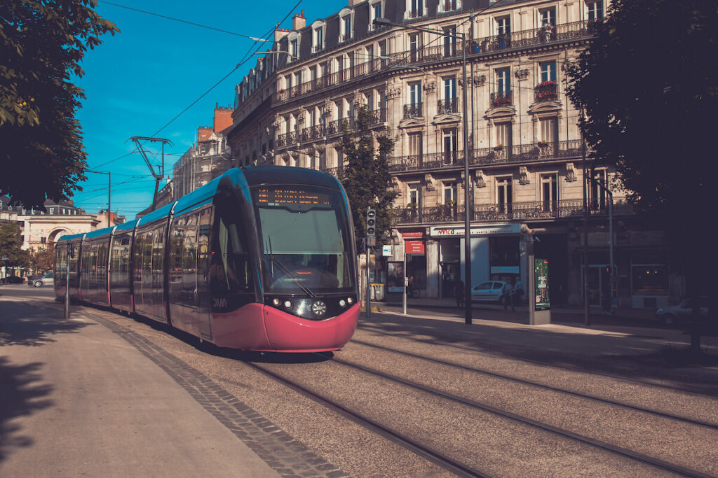 A pink tram on square Place Darcy in famous city Dijon in France