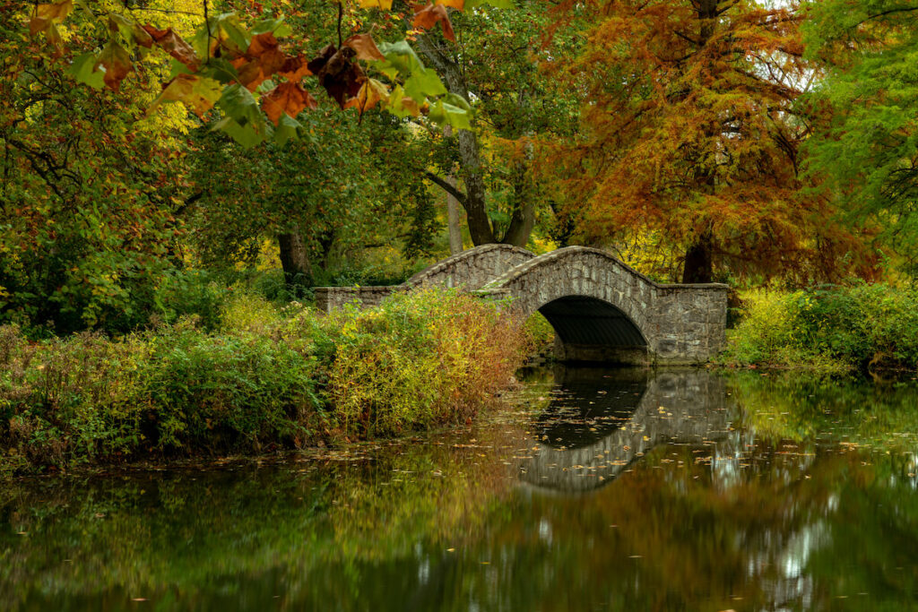 Tranquil water under a stone footbridge at Eastwood Park near Dayton Ohio