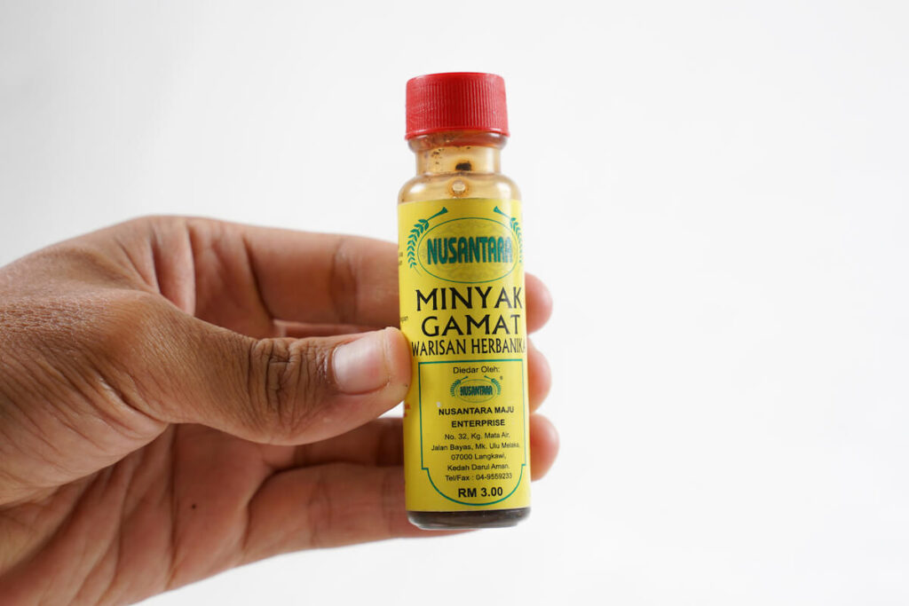 Hand holding gamat oil